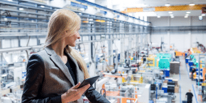 Female product owner surveys the shop floor for factory acceptance testing.